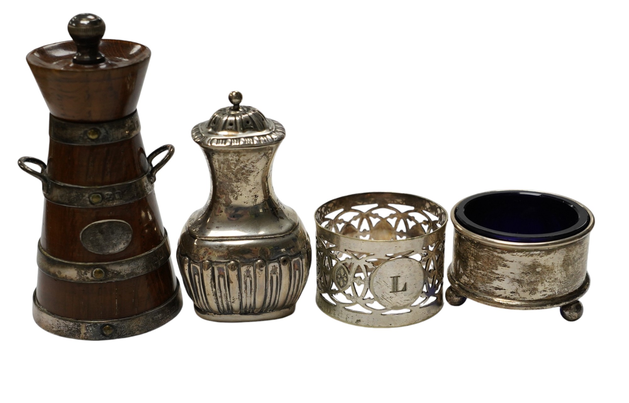 Small silver to include a cased Victorian silver Queens pattern christening trio, London 1837, four various silver napkin rings, a plated napkin ring, two condiments and a silver mounted wooden 'milk churn' pepper mill.